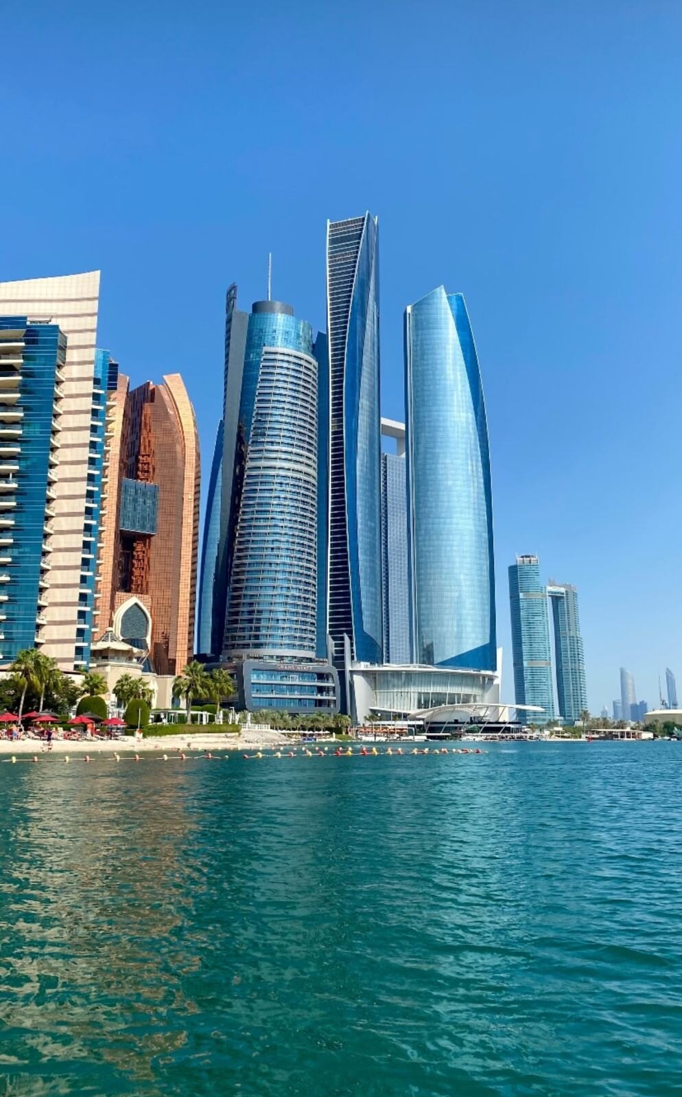 Abu Dhabi skyline lit from end to end, seen from the water